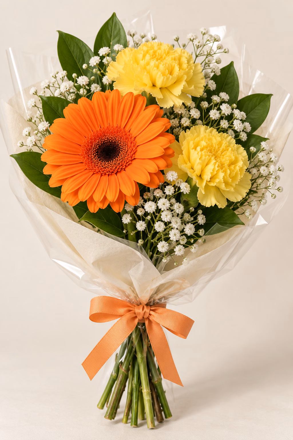 Citrus Joy Budget Bouquet: 1 orange gerbera, 2 yellow standard carnations, a few salal leaves and a light touch of baby's breath. Traditionally hand-tied with simple tissue and clear wrapping, finished with a coordinating ribbon.