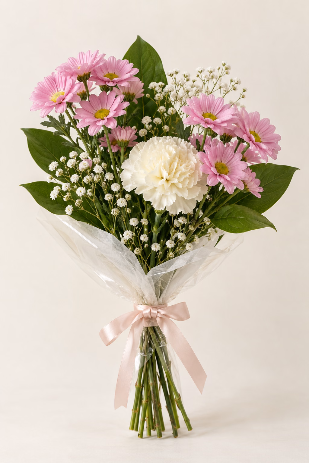 Pink Daisy Budget Bouquet: 2 pink daisy spray chrysanthemum stems, 1 cream standard carnation, a few salal leaves and a light touch of baby's breath. Traditionally hand-tied with simple tissue and clear wrapping, finished with a coordinating ribbon.