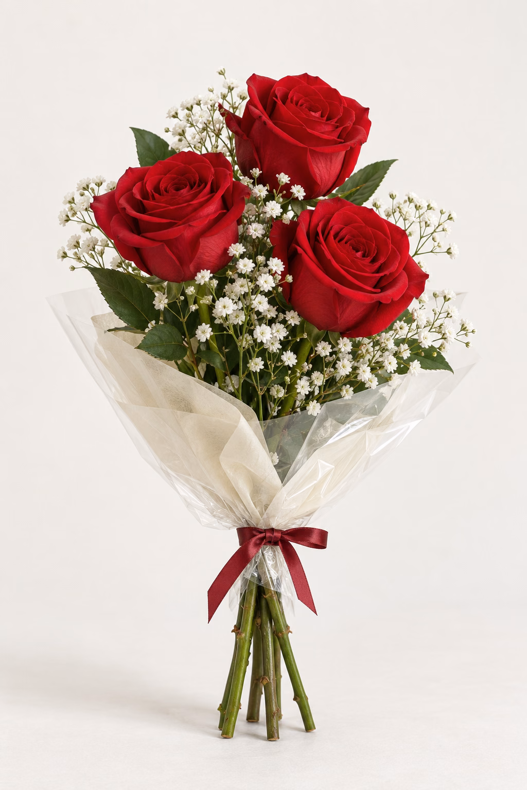 Crimson Letter 3-Rose Bouquet: Three red roses, white baby's breath and greenery. Traditionally hand-tied in simple tissue and clear wrapping with a coordinating ribbon.