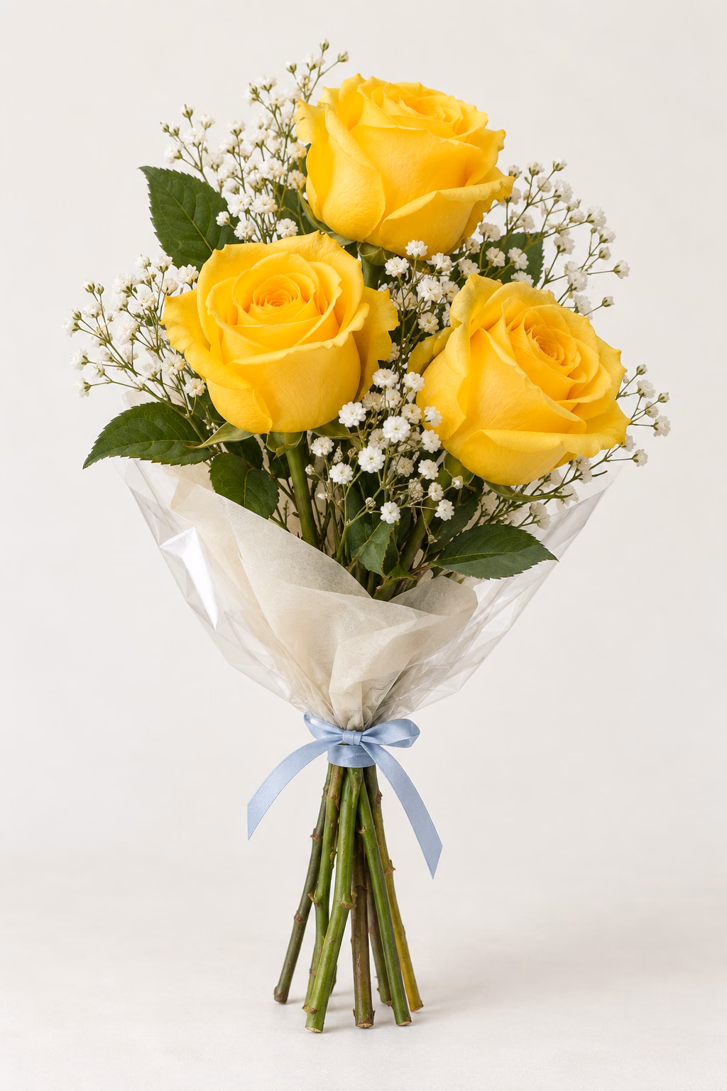 Lemon Ribbon 3-Rose Bouquet: Three yellow roses, white baby's breath and greenery. Traditionally hand-tied in simple tissue and clear wrapping with a coordinating ribbon.